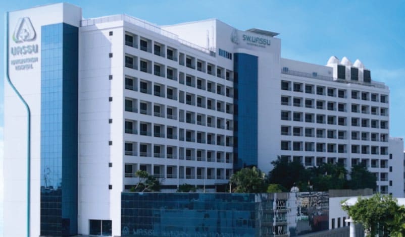Nakornthon Hospital, a white multi-storey hospital with blue glass bays and Thai and English signs