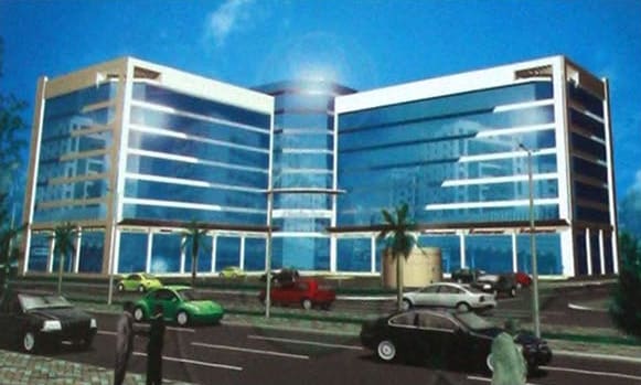 Rendering of a glass-fronted building with two wings around a central glass core, with cars on the road in front