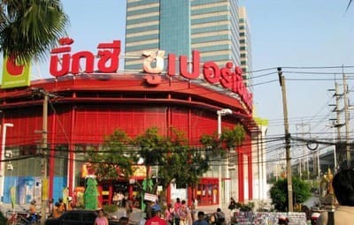 Big C Bangna, a red-fronted Big C Supercenter with a curved facade and shoppers crossing the forecourt