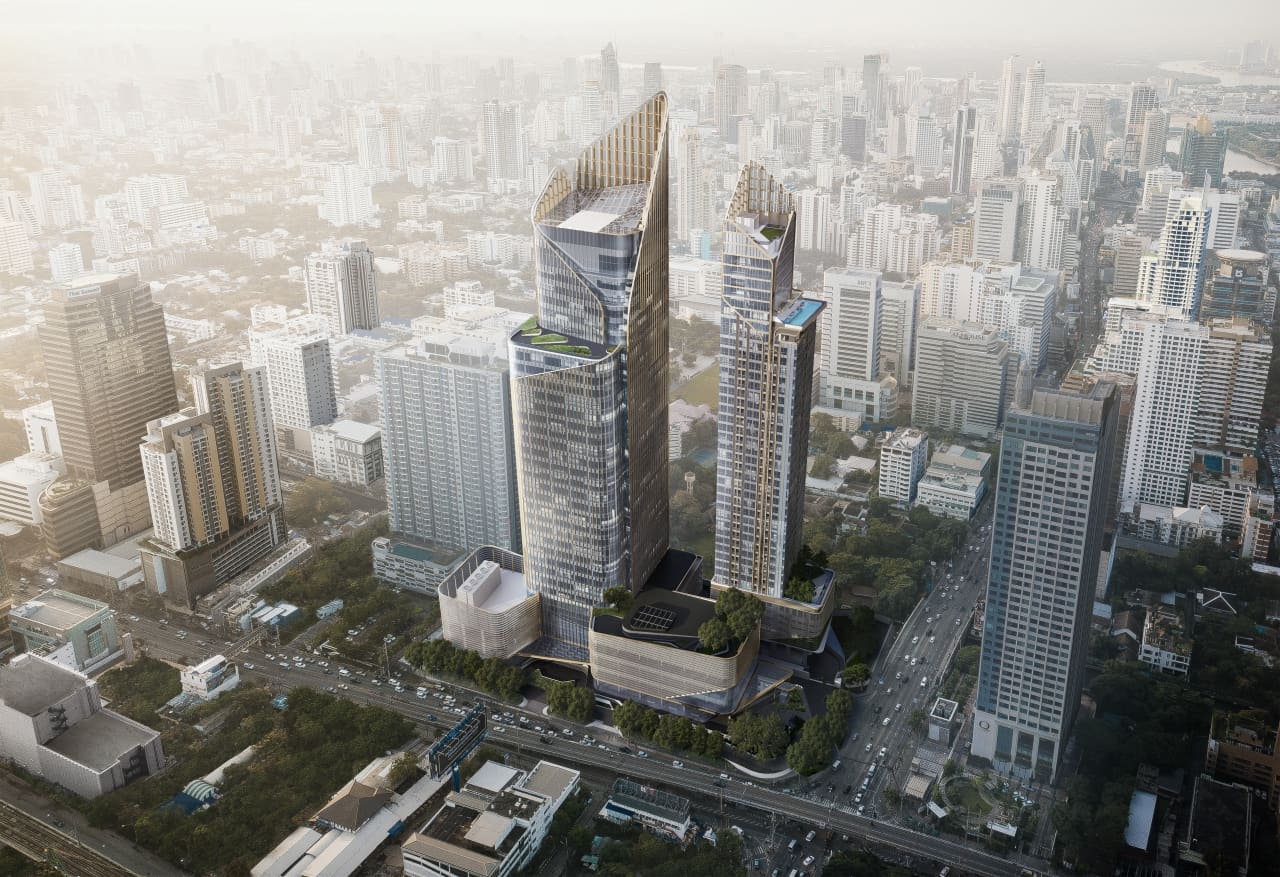 Aerial rendering of The Esse Singha Complex, two sculpted towers on a green podium in a dense city district